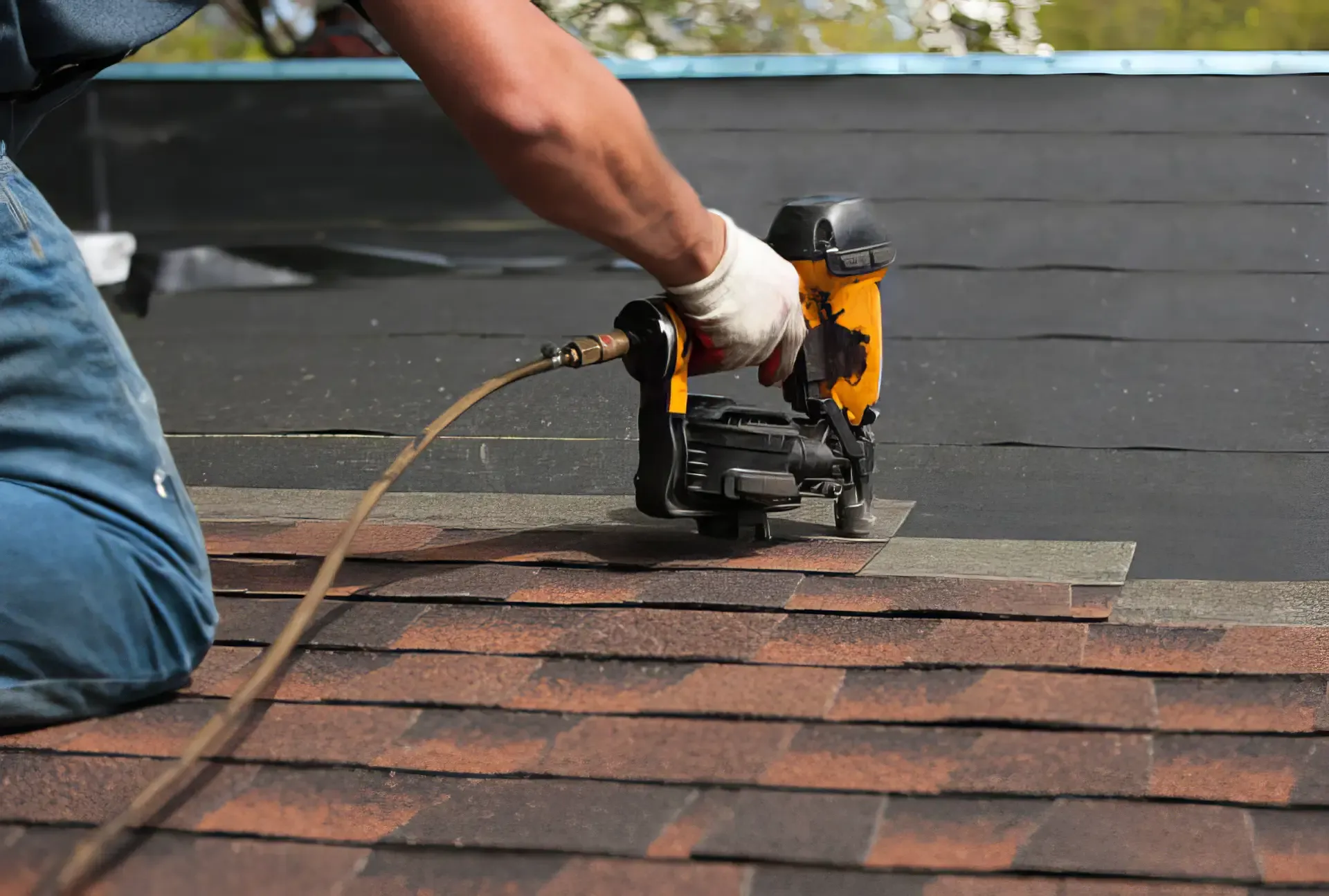 A MOR+ roofer installing new shingles to a home